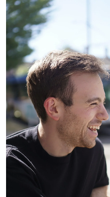 Smiling young man outdoors, reflecting hope in recovery.
